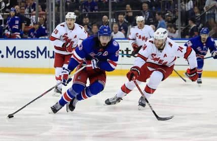 May 22, 2022; New York, New York, USA; New York Rangers center Mika Zibanejad (93) skates with the puck against Carolina Hurricanes defenseman Jaccob Slavin (74) during the second period in game three of the second round of the 2022 Stanley Cup Playoffs at Madison Square Garden. Mandatory Credit: Danny Wild-USA TODAY Sports