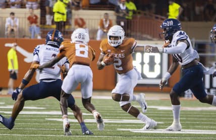 Sep 17, 2022; Austin, Texas, USA; Texas Longhorns running back Roschon Johnson (2) carries for extra yards against the UTSA Roadrunner defense during the first quarter at Darrell K Royal-Texas Memorial Stadium. Mandatory Credit: John Gutierrez-USA TODAY Sports