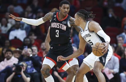 Dec 19, 2022; Houston, Texas, USA; San Antonio Spurs guard Romeo Langford (35) controls the ball as Houston Rockets guard Kevin Porter Jr. (3) defends during the first quarter at Toyota Center. Mandatory Credit: Troy Taormina-USA TODAY Sports