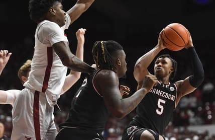 Jan 9, 2024; Tuscaloosa, Alabama, USA; South Carolina guard Meechie Johnson (5) shoots the ball defended by Alabama forward Nick Pringle (23) during the game Coleman Coliseum. Mandatory Credit: Gary Cosby Jr.-USA TODAY Sports