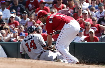 Jul 2, 2022; Cincinnati, Ohio, USA; Atlanta Braves left fielder Adam Duvall (14) is picked-off at first by Cincinnati Reds first baseman Mike Moustakas (9) during the second inning at Great American Ball Park. Mandatory Credit: David Kohl-USA TODAY Sports