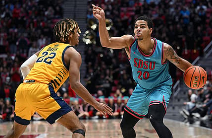 Nov 29, 2022; San Diego, California, USA; San Diego State Aztecs guard Matt Bradley (20) gestures while dribbling the ball as UC Irvine Anteaters guard DJ Davis (22) defends during the second half at Viejas Arena. Mandatory Credit: Orlando Ramirez-USA TODAY Sports