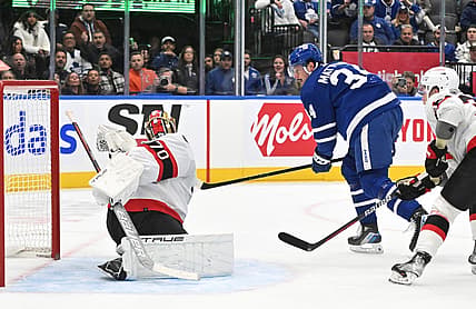 Nov 8, 2023; Toronto, Ontario, CAN; Ottawa Senators goalie Joonas Korpisalo (70) makes a glove save on Toronto Maple Leafs forward Auston Matthews (34) in the first period at Scotiabank Arena. Mandatory Credit: Dan Hamilton-USA TODAY Sports