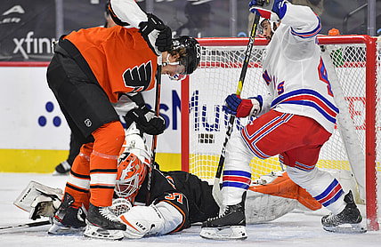 Feb 24, 2021; Philadelphia, Pennsylvania, USA; Philadelphia Flyers goaltender Brian Elliott (37) covers the puck with help from defenseman Travis Sanheim (6) against New York Rangers center Colin Blackwell (43) during the first period at Wells Fargo Center. Mandatory Credit: Eric Hartline-USA TODAY Sports