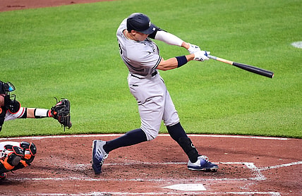 Apr 27, 2021; Baltimore, Maryland, USA; New York Yankees outfielder Aaron Judge (99) hits a home run during the third inning against the Baltimore Orioles at Oriole Park at Camden Yards. Mandatory Credit: Evan Habeeb-USA TODAY Sports