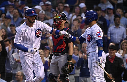 Jun 22, 2021; Chicago, Illinois, USA;  Chicago Cubs first baseman Kris Bryant (left) fist bumps shortstop Javier Baez (9) after hitting a home run against the Cleveland Indians during the fourth inning at Wrigley Field. Mandatory Credit: Matt Marton-USA TODAY Sports