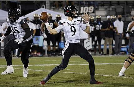 Nov 21, 2020; Orlando, Florida, USA; Cincinnati Bearcats quarterback Desmond Ridder (9) throws a pass against the UCF Knights during the second half at the Bounce House. Mandatory Credit: Reinhold Matay-USA TODAY Sports