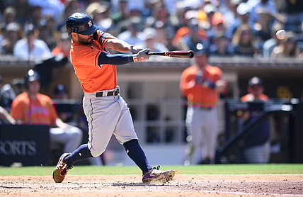 Sep 5, 2021; San Diego, California, USA; Houston Astros second baseman Jose Altuve (27) hits a single against the San Diego Padres during the sixth inning at Petco Park. Mandatory Credit: Orlando Ramirez-USA TODAY Sports