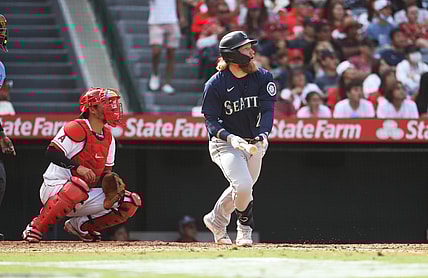 Sep 26, 2021; Anaheim, California, USA; Seattle Mariners left fielder Jake Fraley (28) hits a double against the Los Angeles Angels in the eighth inning at Angel Stadium. Mandatory Credit: Kiyoshi Mio-USA TODAY Sports