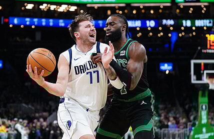 Mar 1, 2024; Boston, Massachusetts, USA; Dallas Mavericks guard Luka Doncic (77) drives the ball against Boston Celtics guard Jaylen Brown (7) in the first quarter at TD Garden. Mandatory Credit: David Butler II-USA TODAY Sports