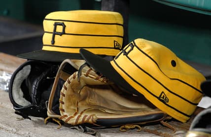 Jul 20, 2019; Pittsburgh, PA, USA;  Pittsburgh Pirates hats and gloves in the dugout against the Philadelphia Phillies during the fifth inning at PNC Park. Pittsburgh won 5-1. Mandatory Credit: Charles LeClaire-USA TODAY Sports