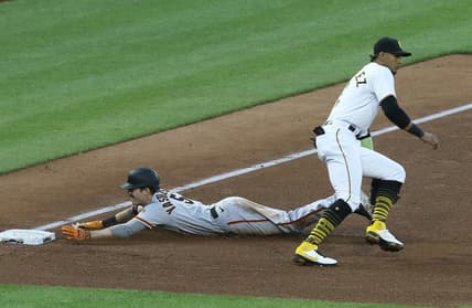 May 13, 2021; Pittsburgh, Pennsylvania, USA;  San Francisco Giants right fielder Mike Yastrzemski (5) slides into third base with an RBI triple as Pittsburgh Pirates third baseman Erik Gonzalez (2) awaits the throw during the fifth inning at PNC Park. Mandatory Credit: Charles LeClaire-USA TODAY Sports