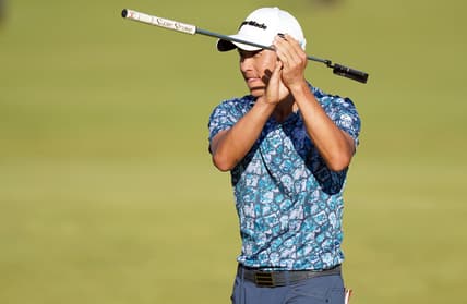 Jul 18, 2021; Sandwich, England, GBR; Collin Morikawa applauds the crowds in the stand of the 18 hole as he wins  the Open Championship golf tournament. Mandatory Credit: Peter van den Berg-USA TODAY Sports