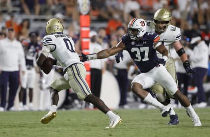 Sep 4, 2021; Auburn, Alabama, USA;  Akron Zips quarterback DJ Irons (0) avoids Auburn Tigers edge Romello Height (37) during the fourth quarter at Jordan-Hare Stadium. Mandatory Credit: John Reed-USA TODAY Sports