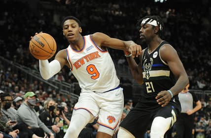 Jan 28, 2022; Milwaukee, Wisconsin, USA; New York Knicks guard RJ Barrett (9) dribbles the ball up court against Milwaukee Bucks guard Jrue Holiday (21) in the second half at Fiserv Forum. Mandatory Credit: Michael McLoone-USA TODAY Sports