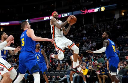Feb 4, 2022; Denver, Colorado, USA; New Orleans Pelicans forward Brandon Ingram (14) shoots the ball past Denver Nuggets center Nikola Jokic (15) and forward Jeff Green (32) in the first quarter at Ball Arena. Mandatory Credit: Ron Chenoy-USA TODAY Sports