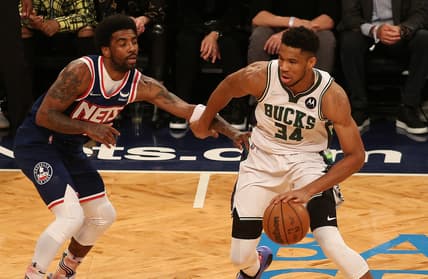 Mar 31, 2022; Brooklyn, New York, USA; Milwaukee Bucks forward Giannis Antetokounmpo (34) dribbles the ball against Brooklyn Nets guard Kyrie Irving (11) during the first half at Barclays Center. Mandatory Credit: Andy Marlin-USA TODAY Sports