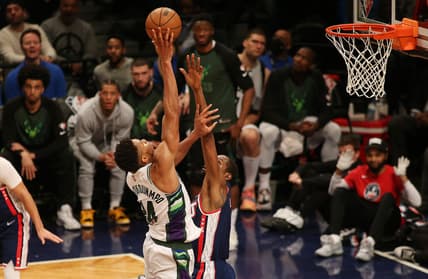 Mar 31, 2022; Brooklyn, New York, USA; Milwaukee Bucks forward Giannis Antetokounmpo (34) goes up for a shot while being defended by Brooklyn Nets forward Kevin Durant (7) during the second half at Barclays Center. Mandatory Credit: Andy Marlin-USA TODAY Sports