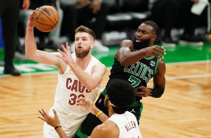 Oct 28, 2022; Boston, Massachusetts, USA; Cleveland Cavaliers forward Dean Wade (32) grabs the rebound against Boston Celtics guard Jaylen Brown (7) in the first quarter at TD Garden. Mandatory Credit: David Butler II-USA TODAY Sports