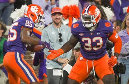 Nov 12, 2022; Clemson, South Carolina, USA; Clemson safety Jalyn Phillips (25) celebrates a fumble recovery defensive tackle Ruke Orhorhoro (33)  playing Louisville during the third quarter at Memorial Stadium in Clemson, South Carolina Saturday, Nov. 12, 2022.     Mandatory Credit: Ken Ruinard-USA TODAY Sports