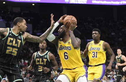 Jan 2, 2023; Charlotte, North Carolina, USA; Los Angeles Lakers forward LeBron James (6) looks to shoot as he is defended by Charlotte Hornets forward P.J. Washington (25) during second half at the Spectrum Center. Mandatory Credit: Sam Sharpe-USA TODAY Sports