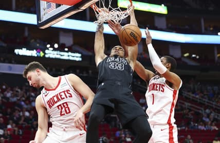 Mar 7, 2023; Houston, Texas, USA; Brooklyn Nets center Nic Claxton (33) dunks the ball as Houston Rockets center Alperen Sengun (28) and forward Jabari Smith Jr. (1) defend during the third quarter at Toyota Center. Mandatory Credit: Troy Taormina-USA TODAY Sports