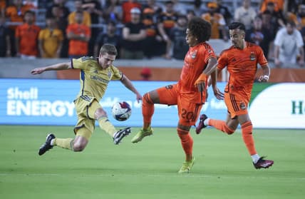 May 6, 2023; Houston, Texas, USA; Real Salt Lake midfielder Scott Caldwell (12) and Houston Dynamo FC midfielder Adalberto Carrasquilla (20) battle for the ball during the first half at Shell Energy Stadium. Mandatory Credit: Troy Taormina-USA TODAY Sports