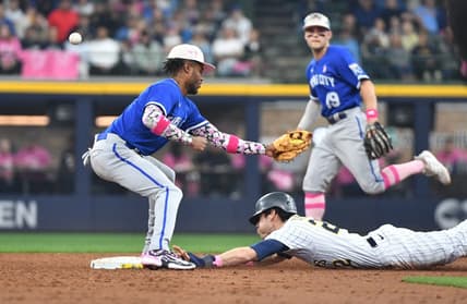 May 14, 2023; Milwaukee, Wisconsin, USA; Milwaukee Brewers left fielder Christian Yelich (22) slides in safely into second base as Kansas City Royals shortstop Maikel Garcia (11) can   t doesn   t make the play at American Family Field. Mandatory Credit: Michael McLoone-USA TODAY Sports