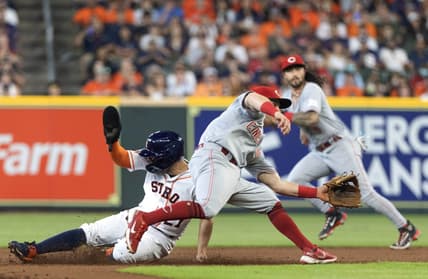 Jun 17, 2023; Houston, Texas, USA; Houston Astros second baseman Jose Altuve (27) steals second base against Cincinnati Reds shortstop Matt McLain (9) n the first inning at Minute Maid Park. Mandatory Credit: Thomas Shea-USA TODAY Sports