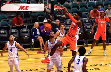 Nov 22, 2023; Honolulu, HI, USA; Syracuse Orange center Naheem McLeod (10) dunks the ball between defenders Chaminade Silverswords forward Wyatt Lowell (25) and forward Chris Bready (3) during the first period at SimpliFi Arena at Stan Sheriff Center. Mandatory Credit: Steven Erler-USA TODAY Sports
