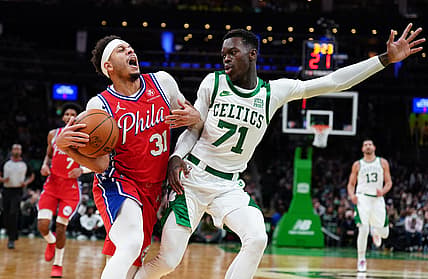 Dec 20, 2021; Boston, Massachusetts, USA; Philadelphia 76ers guard Seth Curry (31) is fouled by Boston Celtics guard Dennis Schroder (71) in the second quarter at TD Garden. Mandatory Credit: David Butler II-USA TODAY Sports