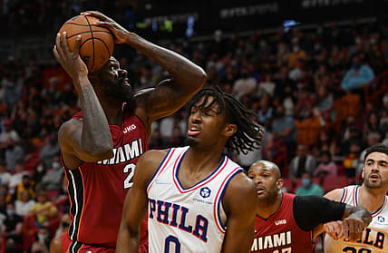 Jan 15, 2022; Miami, Florida, USA; Miami Heat guard Gabe Vincent (2) goes up for a shot over Philadelphia 76ers guard Tyrese Maxey (0) in the first half at FTX Arena. Mandatory Credit: Jim Rassol-USA TODAY Sports