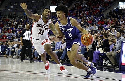 Feb 26, 2022; Fort Worth, Texas, USA; TCU Horned Frogs guard Micah Peavy (0) drives against Texas Tech Red Raiders forward KJ Allen (21) in the first half at Ed and Rae Schollmaier Arena. Mandatory Credit: Tim Heitman-USA TODAY Sports