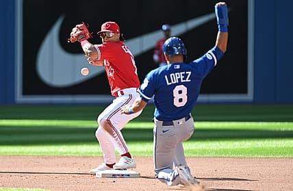 Jul 16, 2022; Toronto, Ontario, CAN;  Toronto Blue Jays second baseman Santiago Espinal (5) mishandles the ball trying for a double play after forcing out Kansas City Royals third baseman Nicky Lopez (8) in the seventh inning at Rogers Centre. Mandatory Credit: Dan Hamilton-USA TODAY Sports