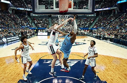 Dec 28, 2022; Hartford, Connecticut, USA; Connecticut Huskies center Donovan Clingan (32) defends against Villanova Wildcats forward Brandon Slater (34) during the first half at XL Center. Mandatory Credit: David Butler II-USA TODAY Sports