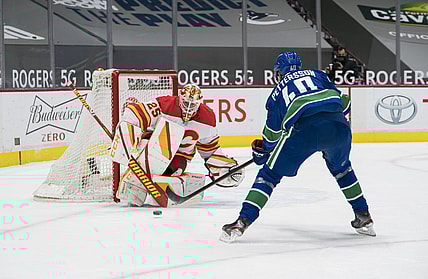 Feb 13, 2021; Vancouver, British Columbia, CAN; Calgary Flames goalie Jacob Markstrom (25) makes a save against Vancouver Canucks forward Elias Pettersson (40) in the first period at Rogers Arena. Mandatory Credit: Bob Frid-USA TODAY Sports