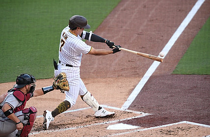 Apr 3, 2021; San Diego, California, USA; San Diego Padres second baseman Ha-seong Kim (7) hits an RBI single during the first inning against the Arizona Diamondbacks at Petco Park. Mandatory Credit: Orlando Ramirez-USA TODAY Sports