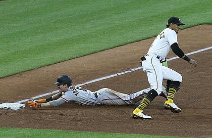 May 13, 2021; Pittsburgh, Pennsylvania, USA;  San Francisco Giants right fielder Mike Yastrzemski (5) slides into third base with an RBI triple as Pittsburgh Pirates third baseman Erik Gonzalez (2) awaits the throw during the fifth inning at PNC Park. Mandatory Credit: Charles LeClaire-USA TODAY Sports