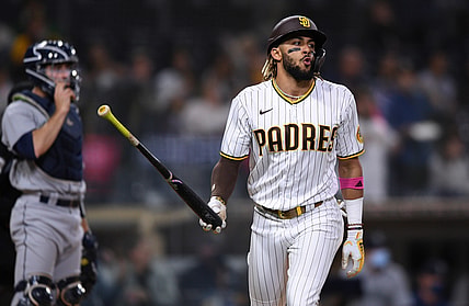 May 21, 2021; San Diego, California, USA; San Diego Padres shortstop Fernando Tatis Jr. (right) tosses his bat after hitting a three-run home run during the second inning as Seattle Mariners catcher Tom Murphy (left) looks on at Petco Park. Mandatory Credit: Orlando Ramirez-USA TODAY Sports