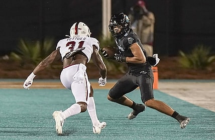 Oct 28, 2021; Conway, South Carolina, USA; Coastal Carolina Chanticleers wide receiver Jaivon Heiligh (6) catches a pass against Troy Trojans safety Dell Pettus (31) during the first half at Brooks Stadium. Mandatory Credit: David Yeazell-USA TODAY Sports