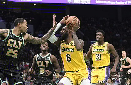 Jan 2, 2023; Charlotte, North Carolina, USA; Los Angeles Lakers forward LeBron James (6) looks to shoot as he is defended by Charlotte Hornets forward P.J. Washington (25) during second half at the Spectrum Center. Mandatory Credit: Sam Sharpe-USA TODAY Sports