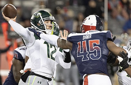 Feb 18, 2023; Houston, TX, USA; Orlando Guardians quarterback Quinten Dormady (12) throws a pass against Houston Roughnecks linebacker John Dana (45) in the fourth quarter at TDECU Stadium. Mandatory Credit: Thomas Shea-USA TODAY Sports