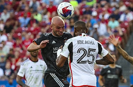 May 20, 2023; Frisco, Texas, USA; Houston Dynamo defender Chase Gasper (30) heads the ball in front of FC Dallas defender Sebastien Ibeagha (25) during the first half at Toyota Stadium. Mandatory Credit: Kevin Jairaj-USA TODAY Sports