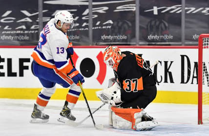 Jan 31, 2021; Philadelphia, Pennsylvania, USA; Philadelphia Flyers goaltender Brian Elliott (37) covers the puck against New York Islanders center Mathew Barzal (13) during the first period at Wells Fargo Center. Mandatory Credit: Eric Hartline-USA TODAY Sports