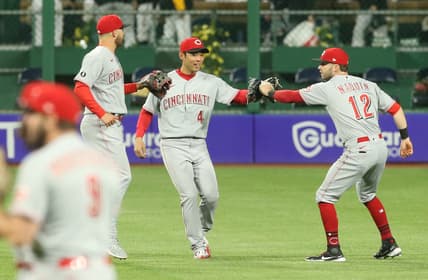 May 10, 2021; Pittsburgh, Pennsylvania, USA; Cincinnati Reds center fielder Nick Senzel (left) and left fielder Shogo Akiyama (4) and right fielder Tyler Naquin (12) celebrate after defeating the Pittsburgh Pirates at PNC Park. The Reds won 14-1. Mandatory Credit: Charles LeClaire-USA TODAY Sports