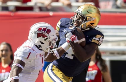 Sep 25, 2021; Chicago, Illinois, USA; Notre Dame Fighting Irish wide receiver Kevin Austin Jr. (4) receives a pass for a touchdown against Wisconsin Badgers cornerback Faion Hicks (1) during the first half at Soldier Field. Mandatory Credit: Patrick Gorski-USA TODAY Sports