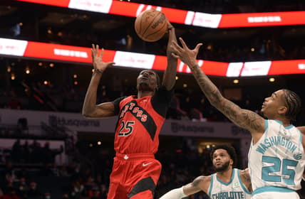 Feb 7, 2022; Charlotte, North Carolina, USA;  Toronto Raptors forward center Chris Boucher (25) and Charlotte Hornets forward PJ Washington (25) fight for a rebound during the first half at the Spectrum Center. Mandatory Credit: Sam Sharpe-USA TODAY Sports