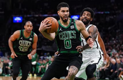 Apr 17, 2022; Boston, Massachusetts, USA; Boston Celtics forward Jayson Tatum (0) drives the ball against Brooklyn Nets guard Kyrie Irving (11) in the second half during game one of the first round for the 2022 NBA playoffs at TD Garden. Mandatory Credit: David Butler II-USA TODAY Sports