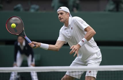 Jun 29, 2022; London, United Kingdom; John Isner (USA) returns a shot during his second round match against Andy Murray (GBR) on day three at All England Lawn Tennis and Croquet Club. Mandatory Credit: Susan Mullane-USA TODAY Sports