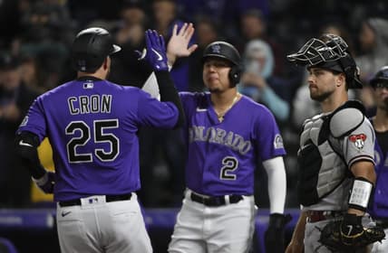 Sep 10, 2022; Denver, Colorado, USA; Colorado Rockies designated hitter C.J. Cron (25) high fives Colorado Rockies center fielder Yonathan Daza (2) after his home run in the sixth inning against the Arizona Diamondbacks at Coors Field. Mandatory Credit: John Leyba-USA TODAY Sports